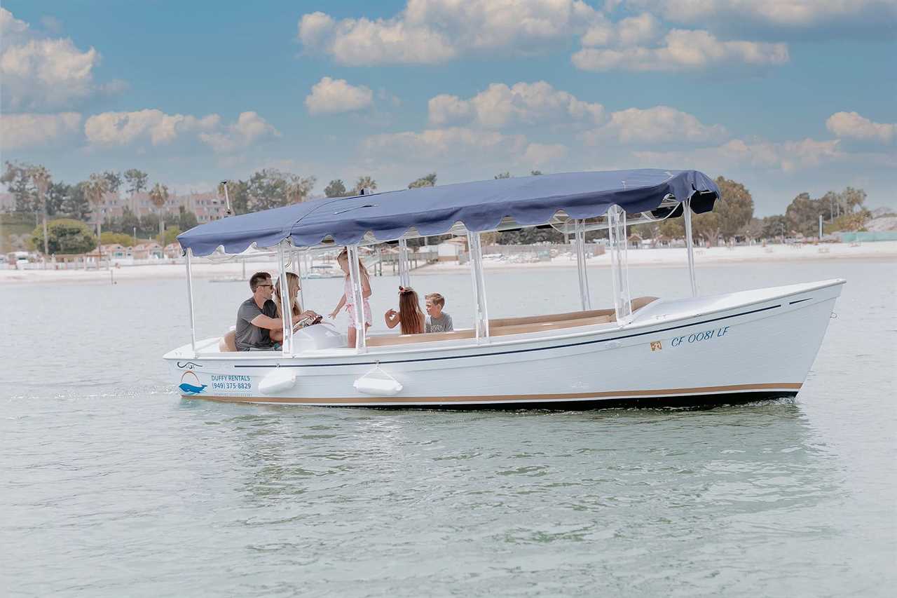 Family riding in a white electric boat.