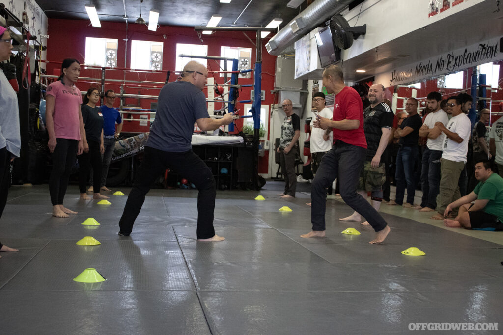 Photo of Patrick Vuong an Conrad Bui, instructors for Tiga Tactics, demonstrating knife defense skills.