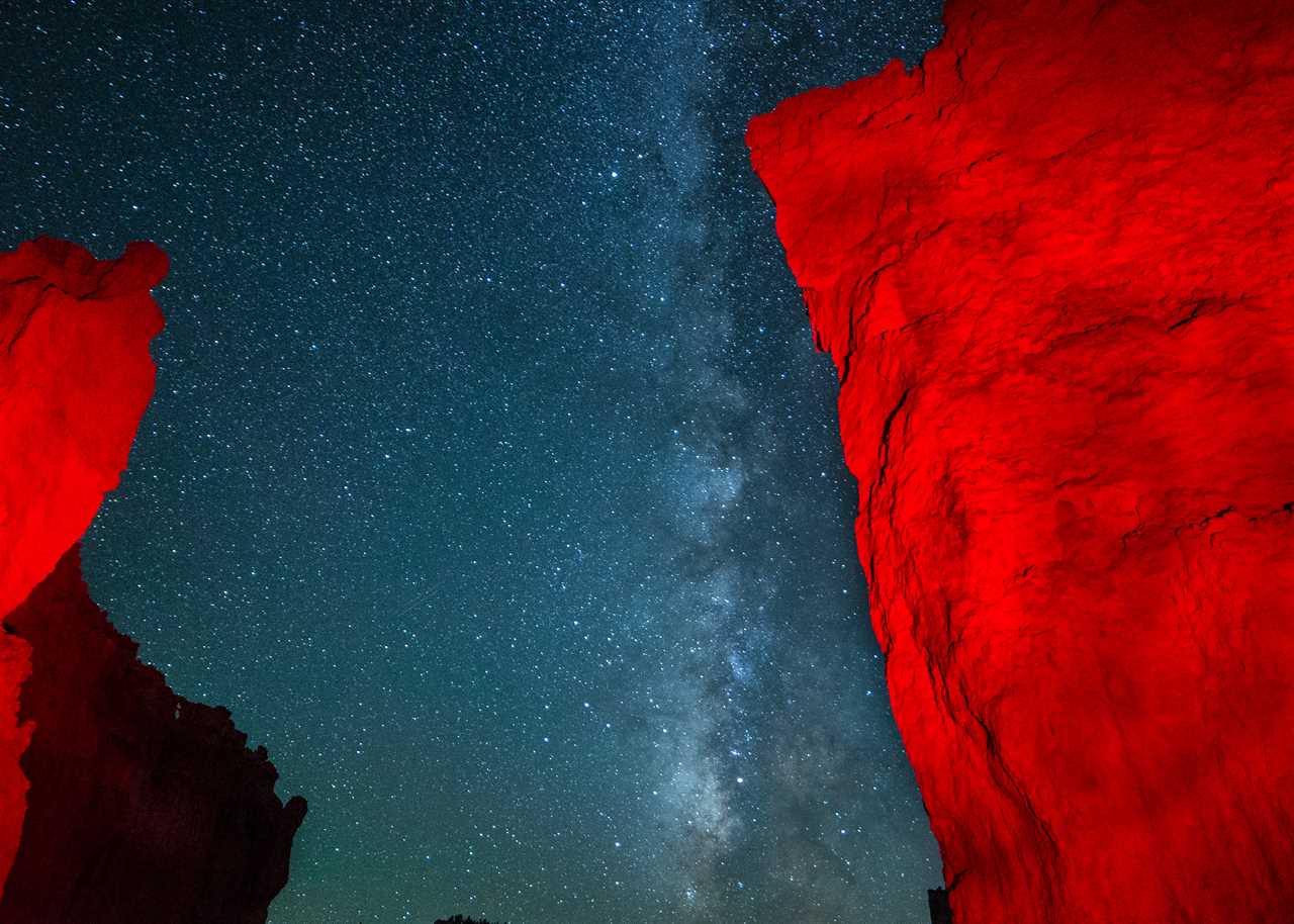 Orange hoodoo against a night sky with the Milky Way