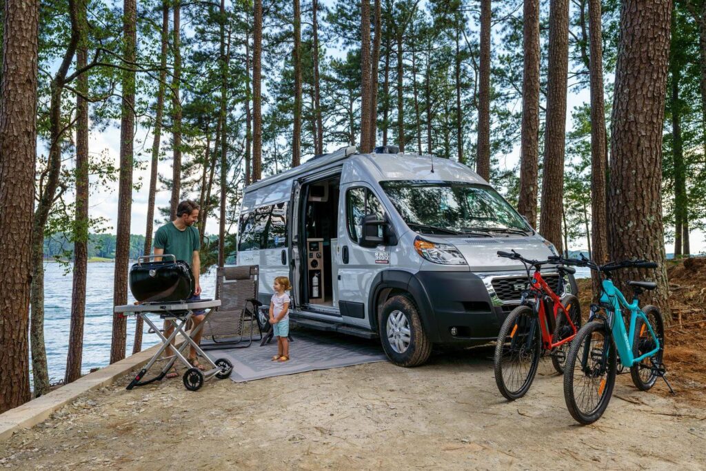 Dad and daughter standing outside RV van camper