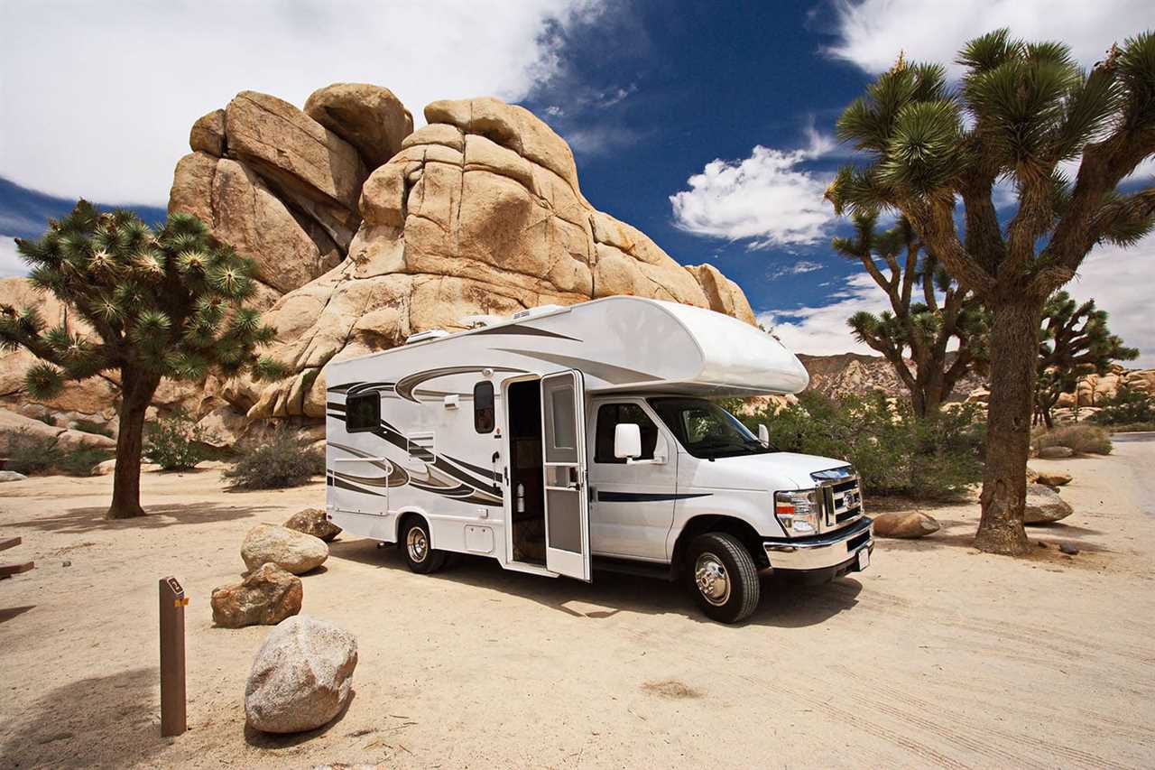 Class C RV amid Joshua trees