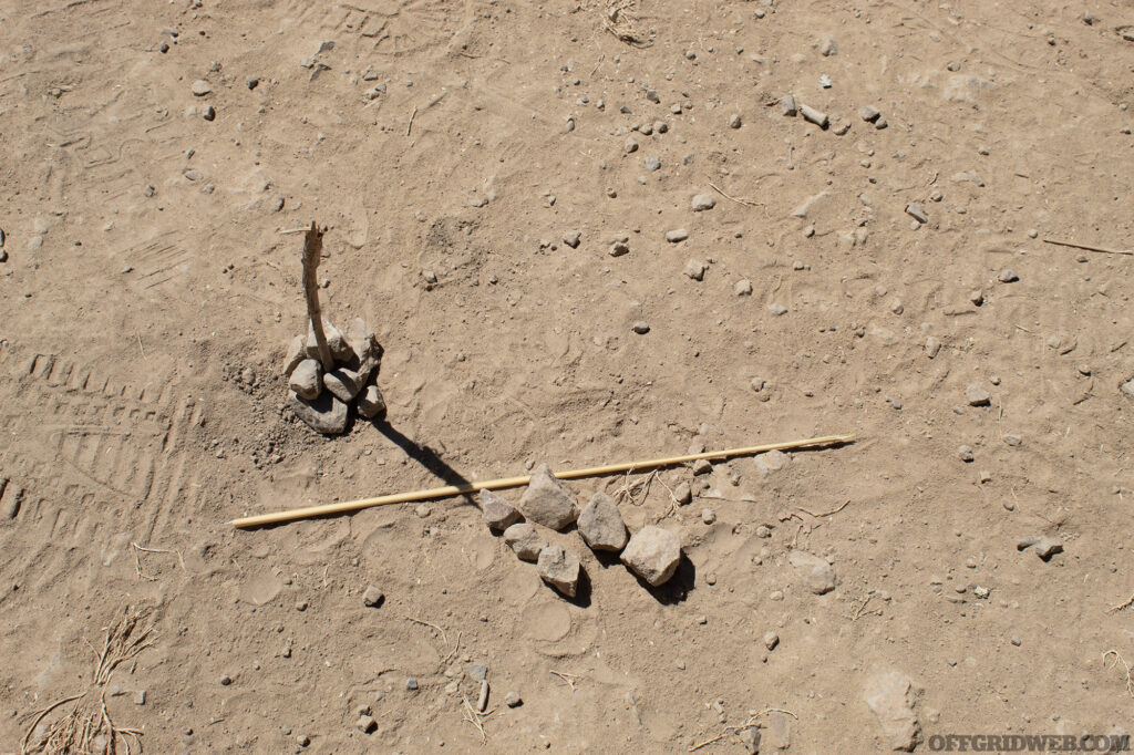 Photo of a sundial with a second row of rocks marking the second shadow measurement.