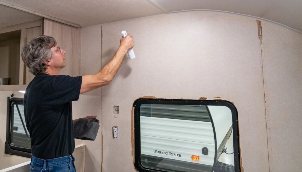 Man prepping RV interior walls for repainting