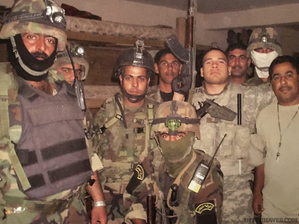 Photo of Raul Martinez working with the Iraqi army.