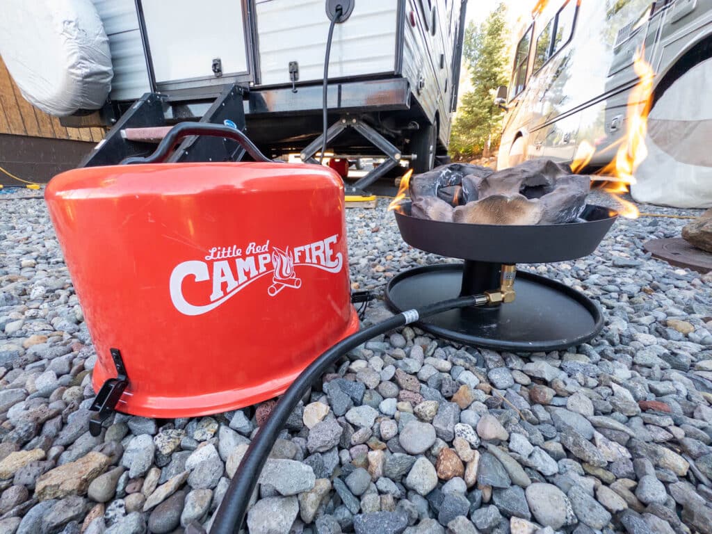 Camco Little Red Campfire lit with lid next to it