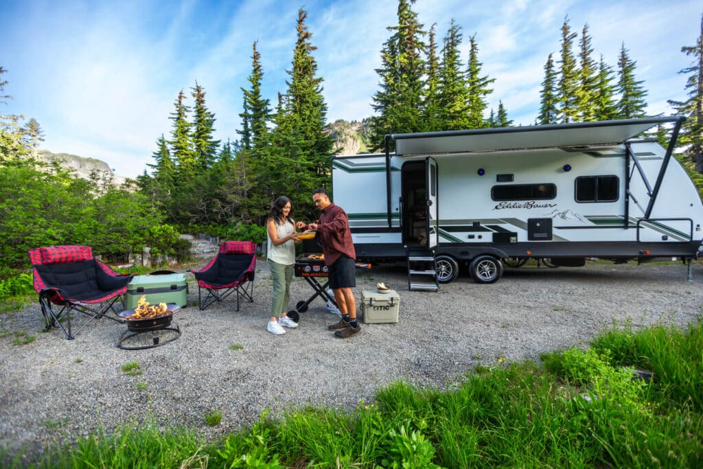 Couple enjoying camping outside their Eddie Bauer RV