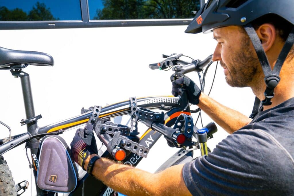 RVer loading e-bike onto bike rack