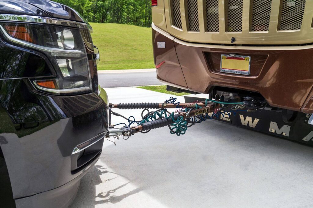 Tow bars connected to vehicle for dinghy towing