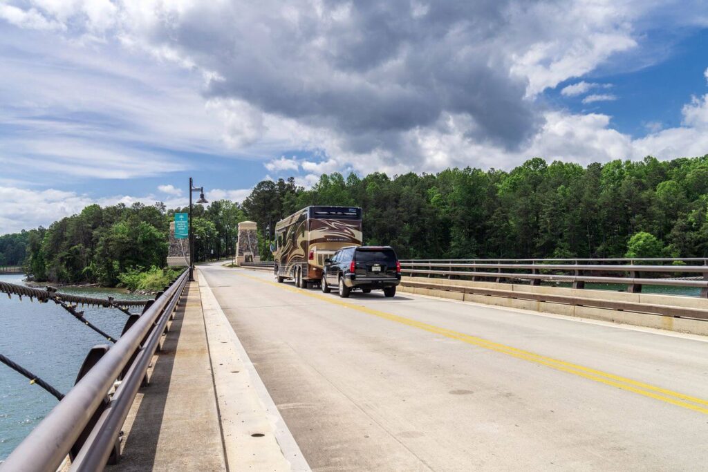 Motorhome towing dinghy over a bridge