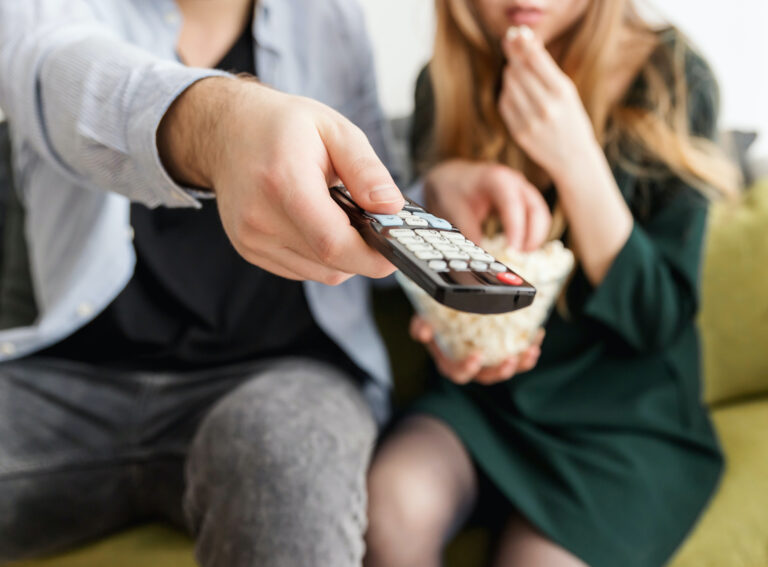 man and woman watching tv