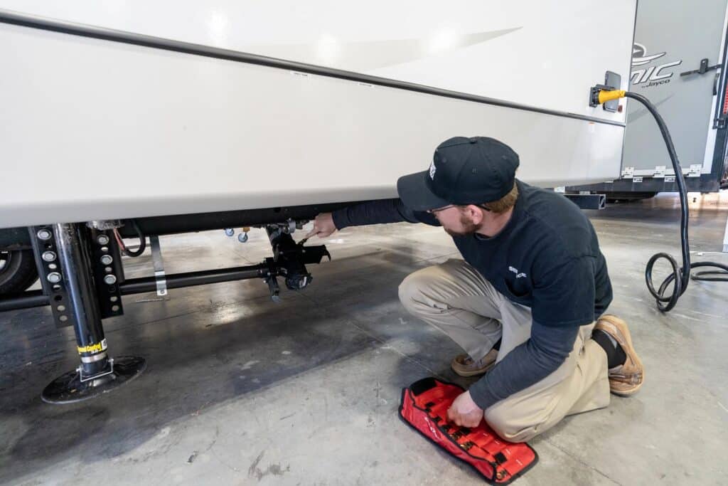 RV Technician working on sewer termination outlet