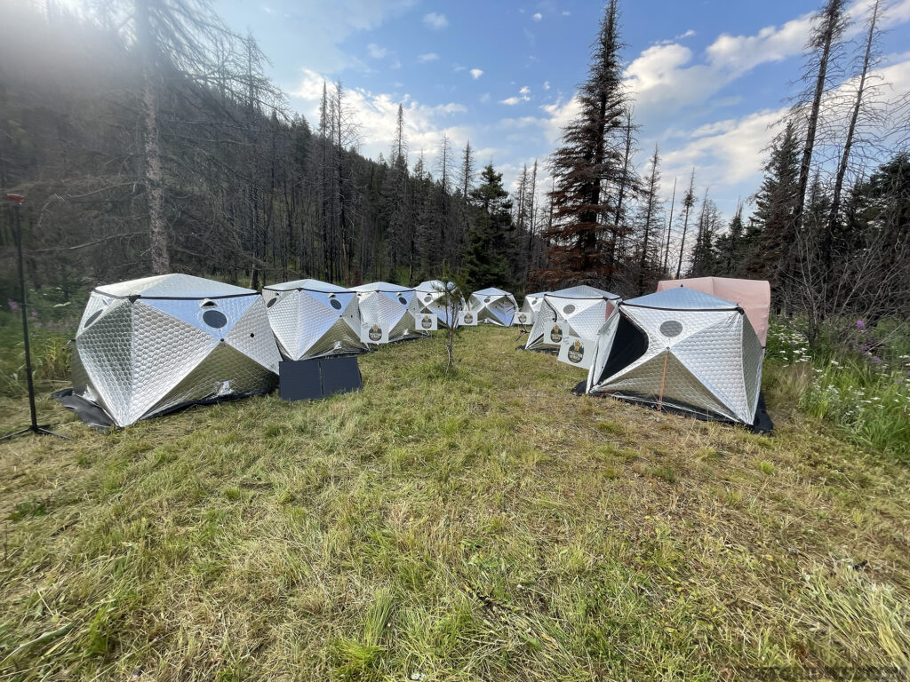 Shiftpod tents set up at the base of a Montana mountainside.