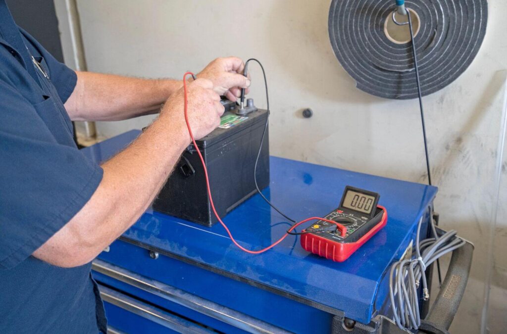 RV Technician testing RV battery