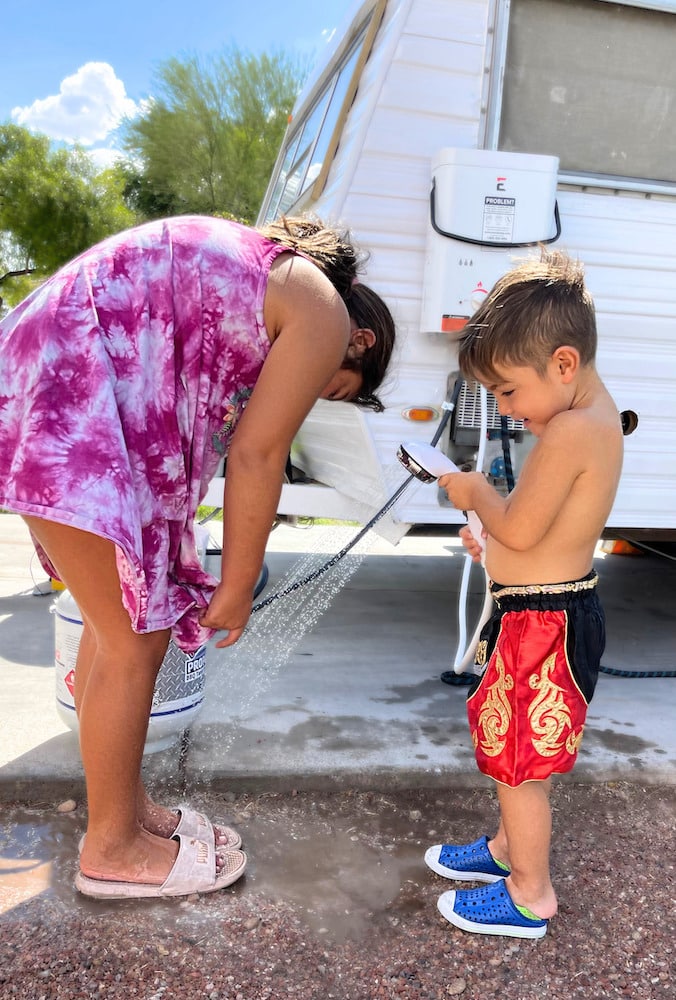 Mother and son washing feet using Eccotemp tankless water heater