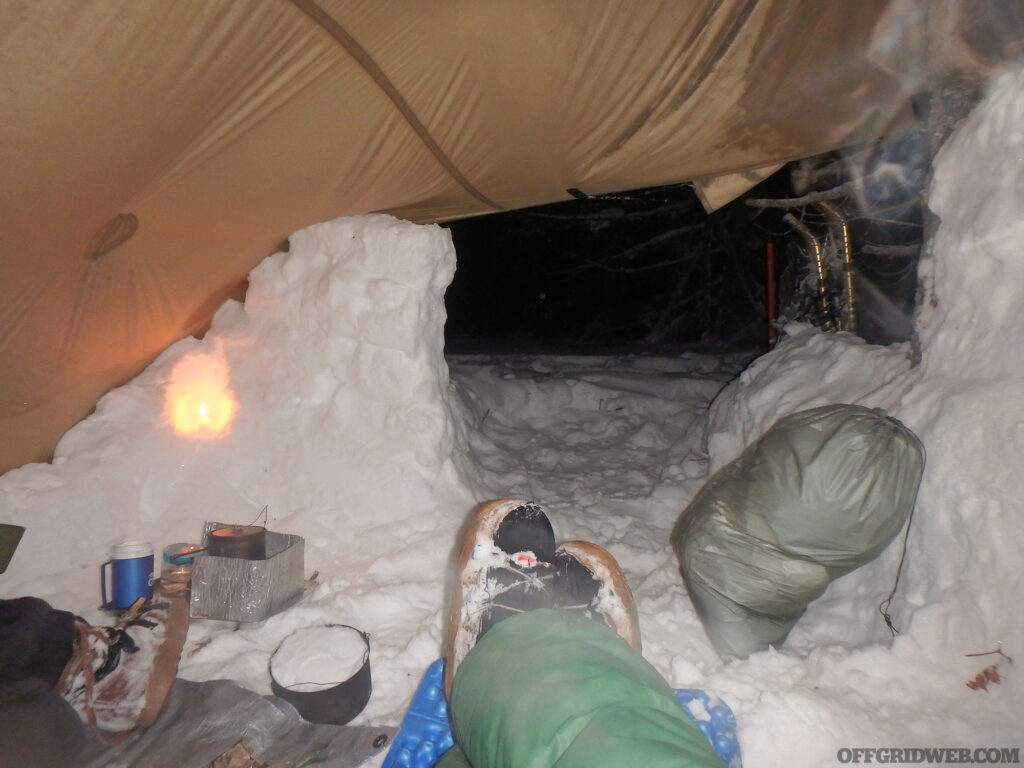 Michael Neiger relaxing on the inside of his snow shelter.