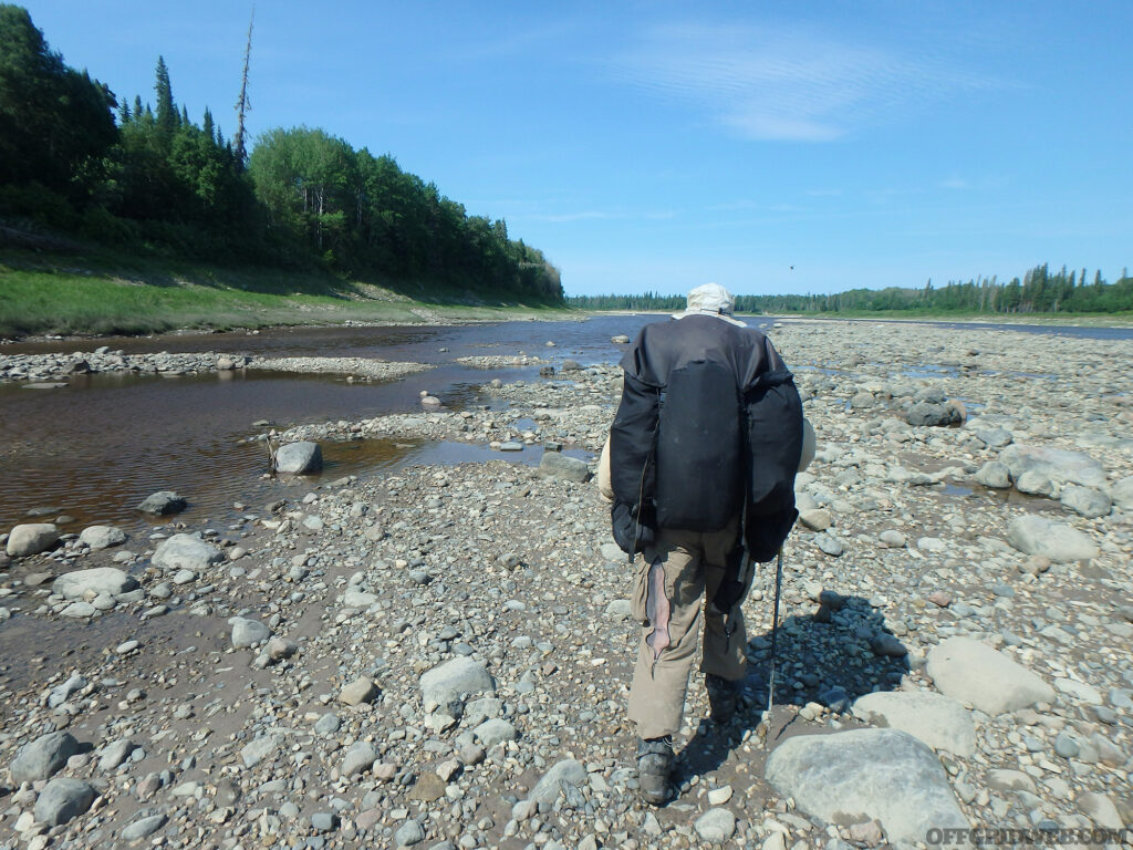 Michael Neiger walking along a river bed.