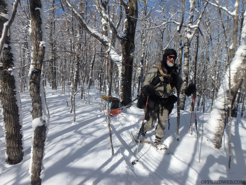 Michael Neiger snowshoeing through a forest.