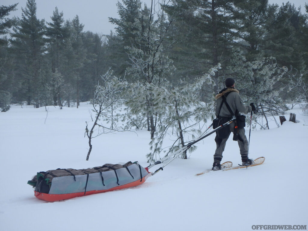 Michael Neiger pulling a toboggan through the snow.