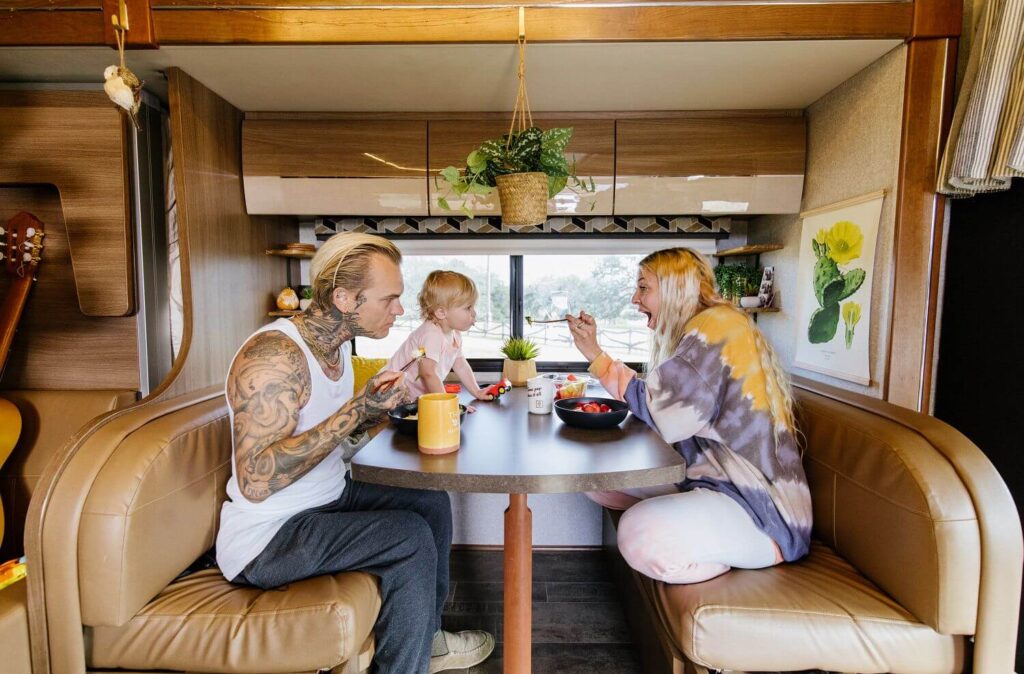 Small family eating at dinette in Class B+ RV