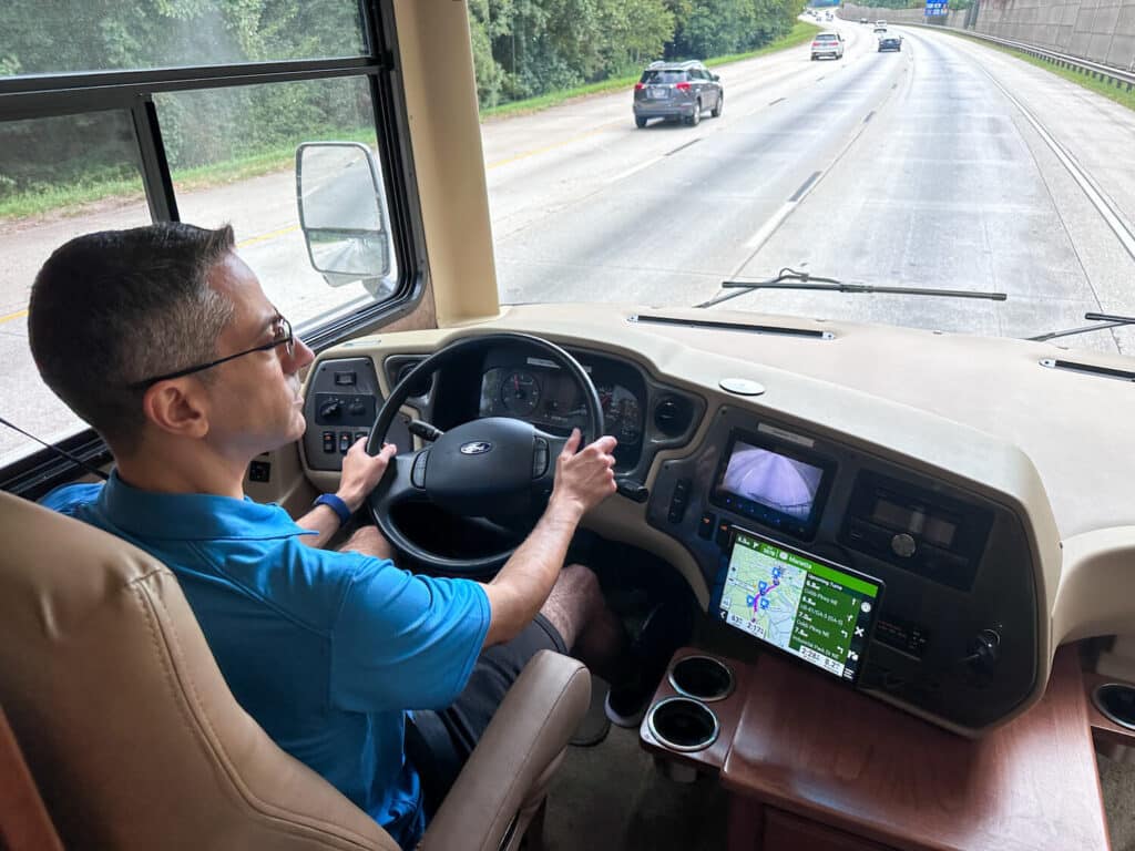 Man driving motorhome using Garmin 1095 for directions