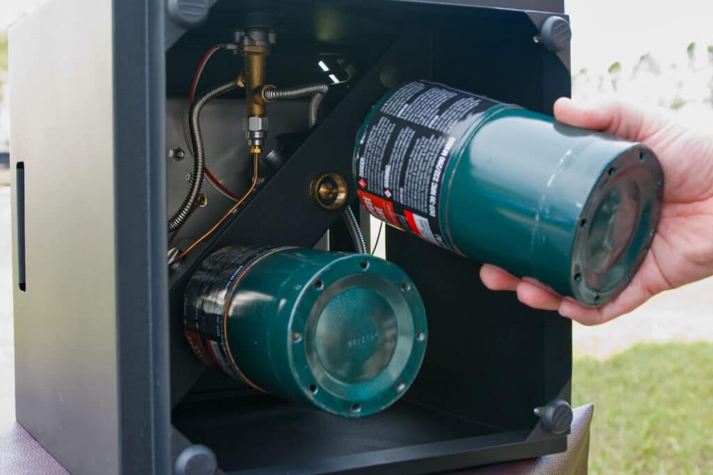 Screwing propane canister into Ukiah Firepit