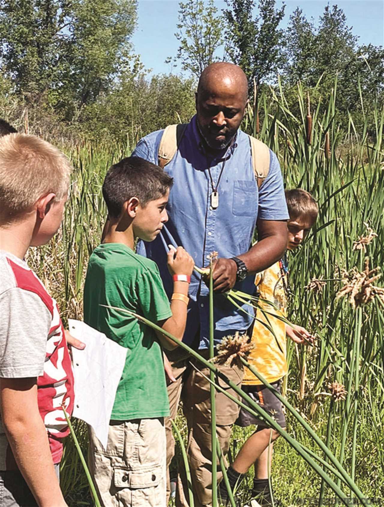 Britt Ahart teaching youth about nature.