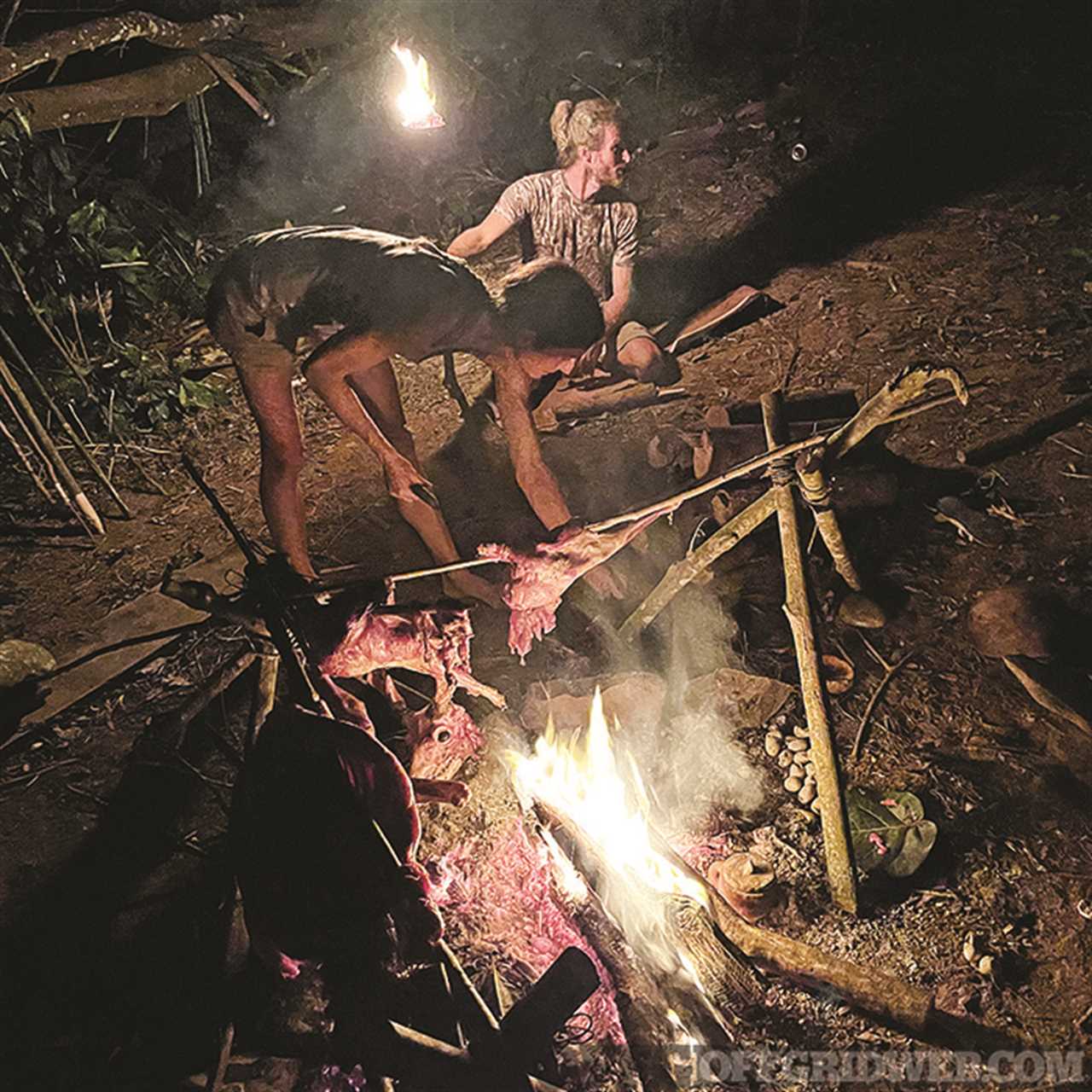 Matt Corradino preparing food over a camp fire.