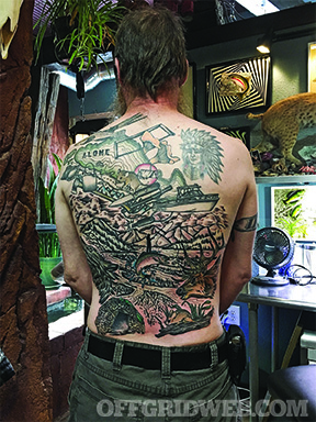 Alone contestant Larry Roberts showing off his back tattoo commemorating his time on the show.