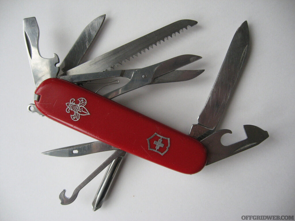 Photo of a swiss army knife with all of its tools and blades on display.