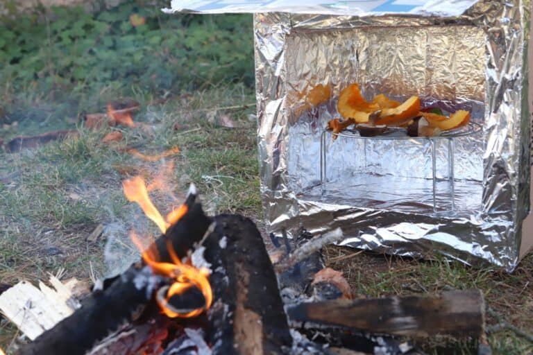 functioning reflector oven next to fire