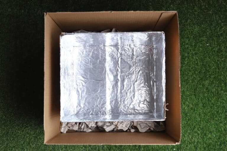 box lined with aluminum foil inside another box