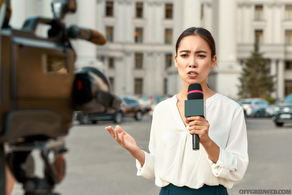 Photo of a news reporter reporting on an event in an urban center.