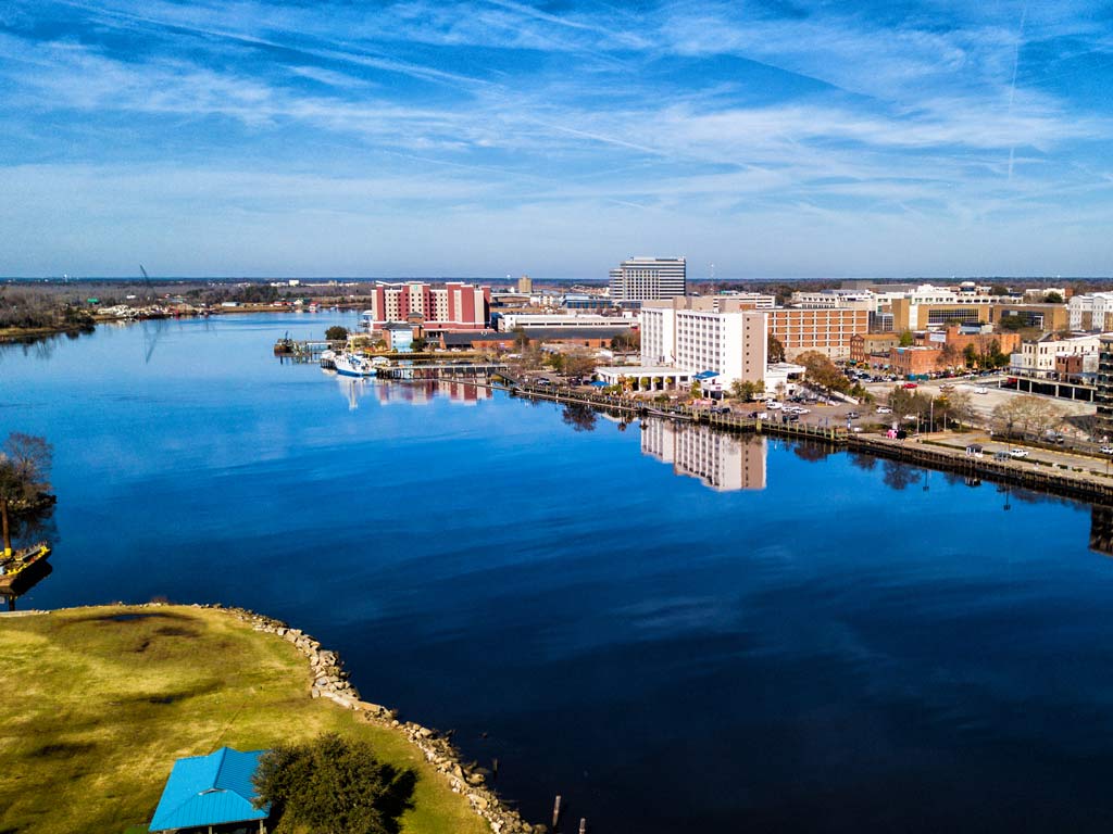 An aerial view of Wilmington, North Carolina looking down the Cape Fear River, which has made the city one of the best fishing destinations in the state.