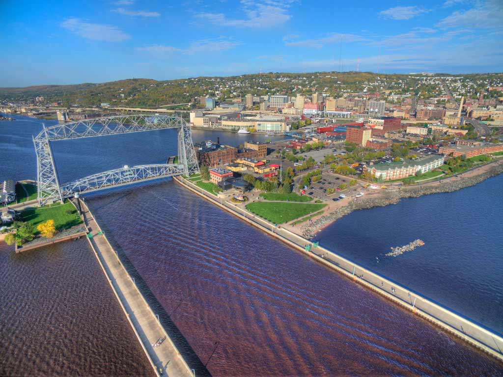 An aerial view of Duluth, Minnesota and the Aerial Lift Bridge located at the shores of Lake Superior on a clear day.