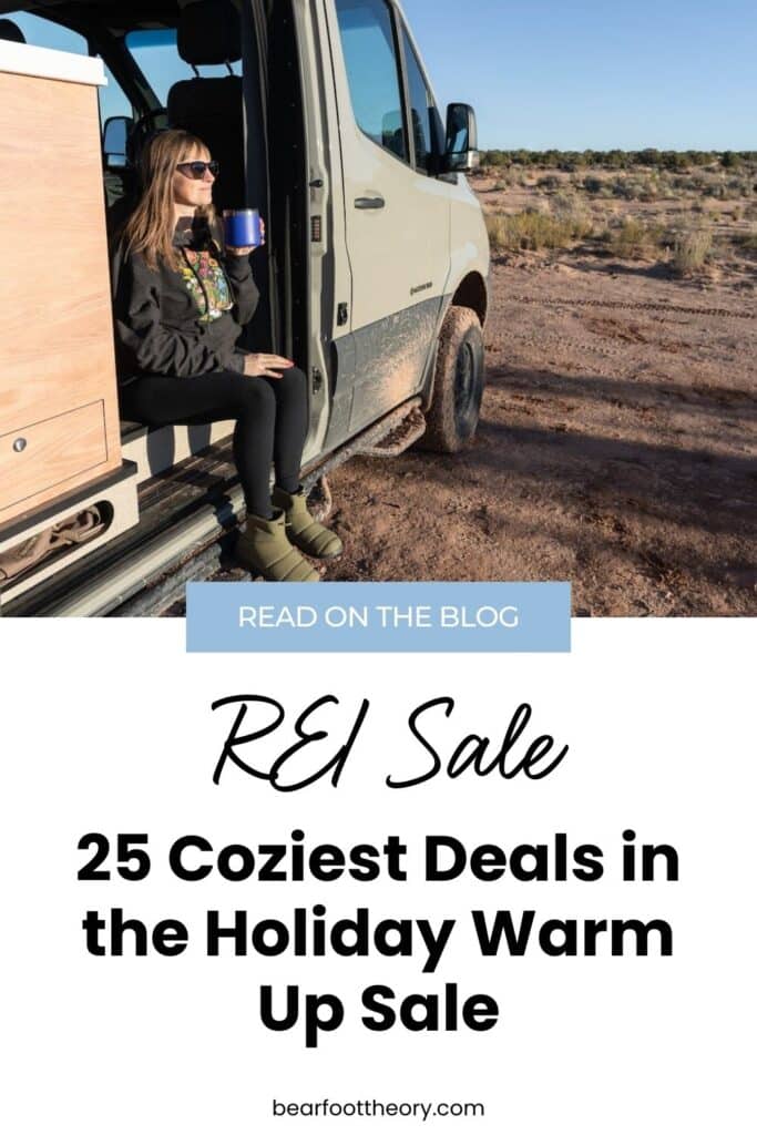 Pinterest image with text that reads "REI Sale - 25 coziest deals in the holiday warm up sale." Image shows a woman drinking coffee with boots on sitting in the doorway of her Sprinter van.