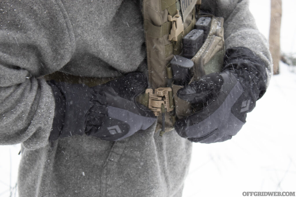 Photo of thickly gloved hands closing the clasp on a plate carrier.