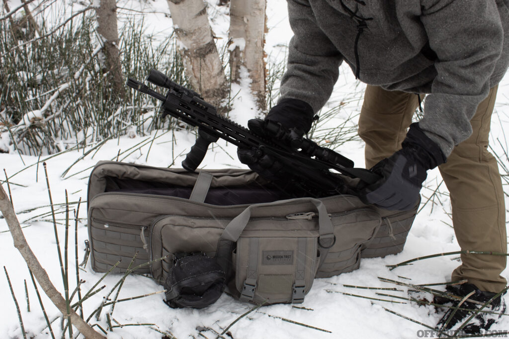 Photo of an AR being removed from a softshell, backpack style firearms case.
