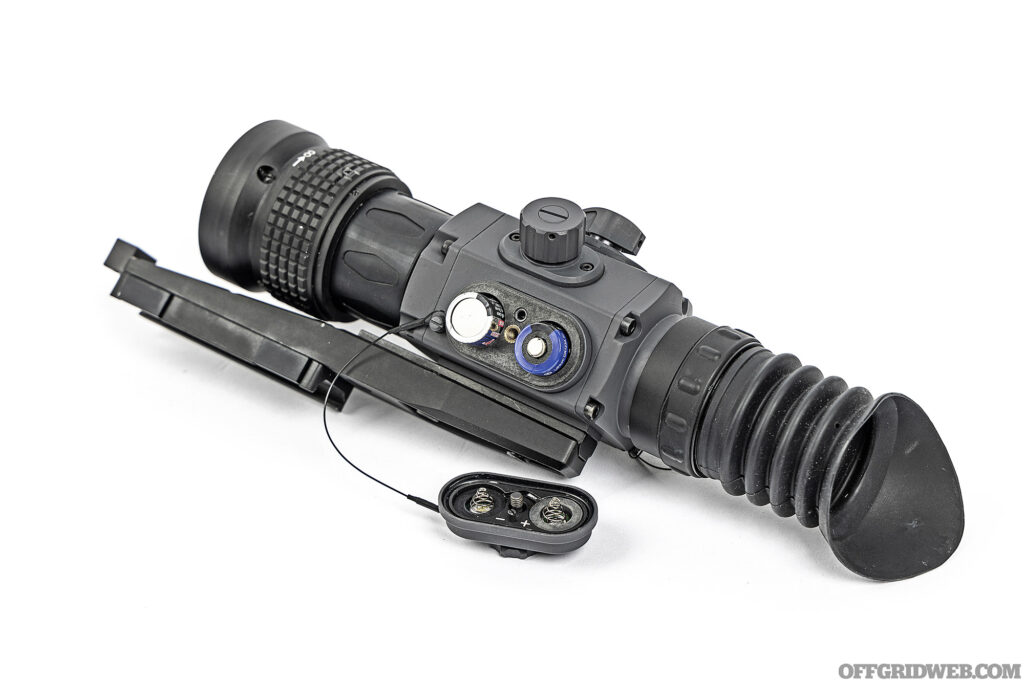 Studio photo of an armasight thermal optic with two batteries in the side.