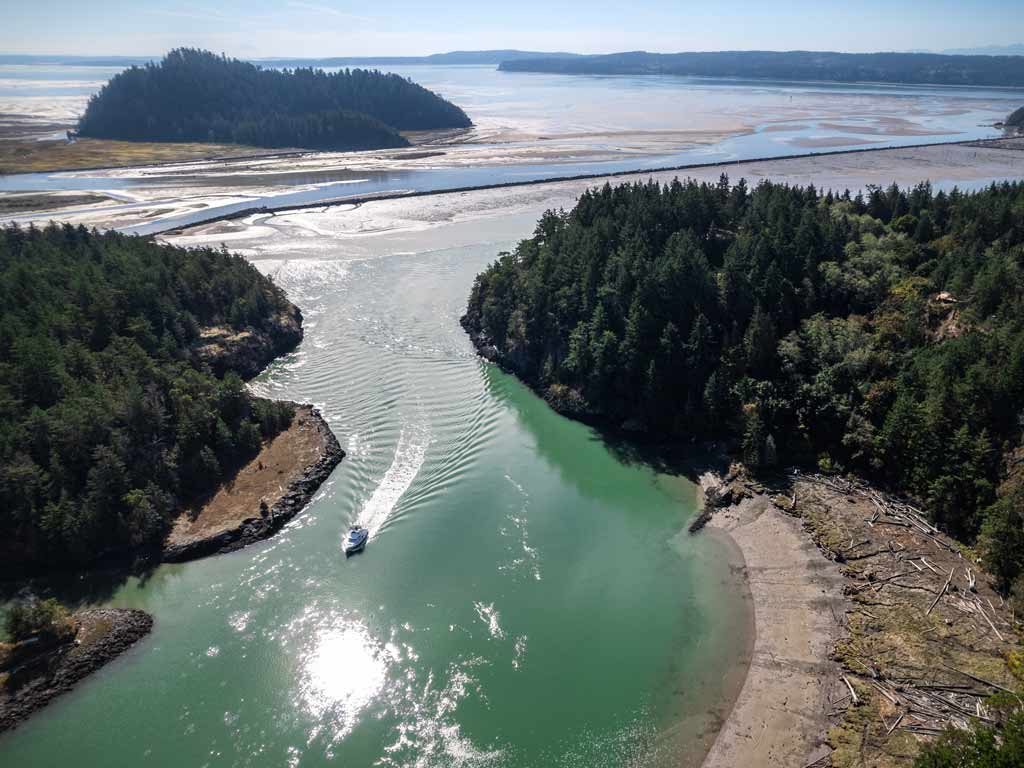 An aerial view of Puget Sound canal and boat on a sunny bright day