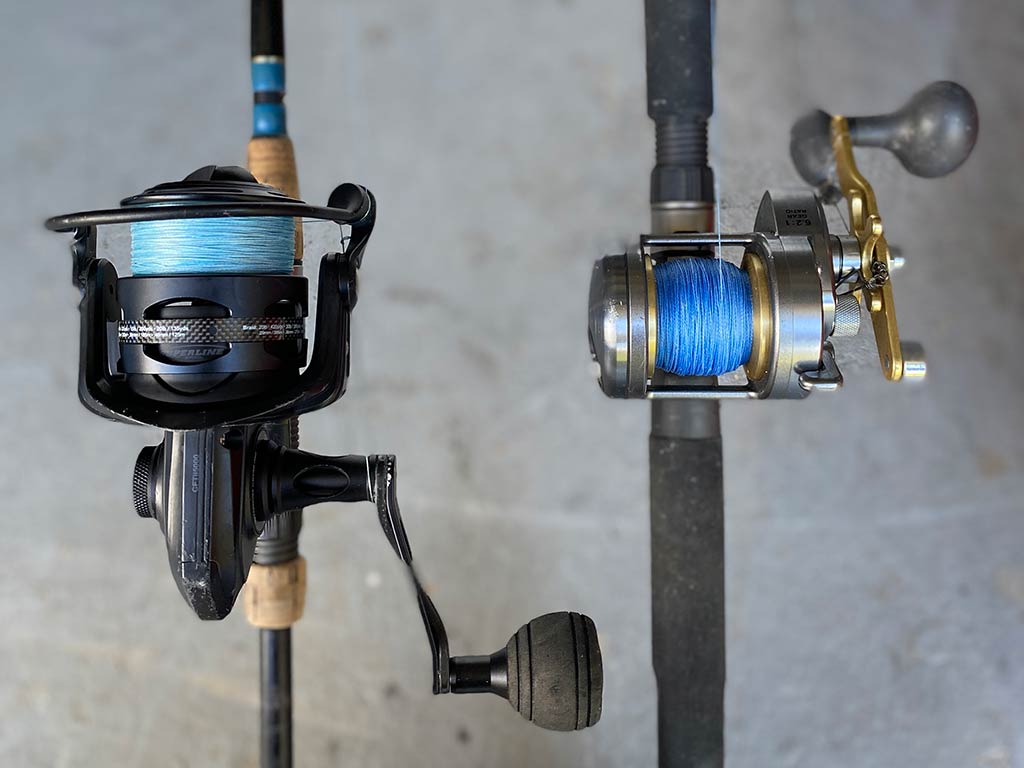 A closeup of two reels on fishing rods suitable for fishing inshore and nearshore, with blue lines fitted on the reels