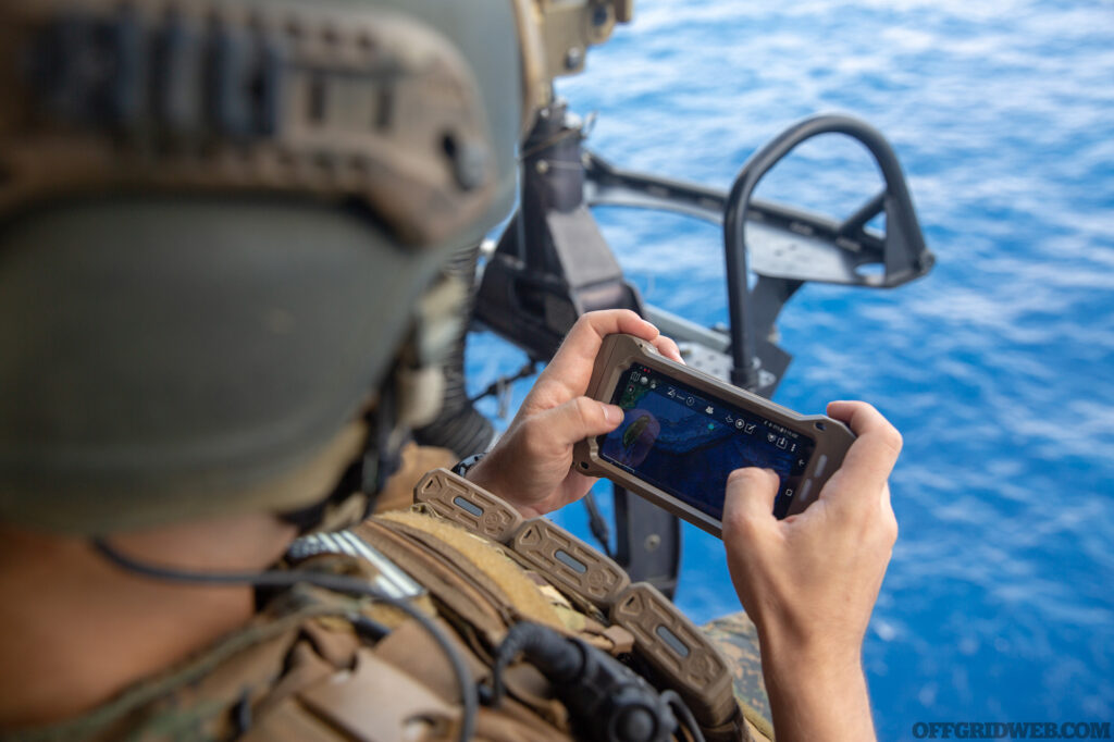 SOUTH CHINA SEA (Sept. 6, 2020) Lance Cpl. Quentin Kachelmeier, a radio operator with the Maritime Raid Force (MRF), 31st Marine Expeditionary Unit (MEU), uses an Android Tactical Assault Kit (ATAK) during a Visit Board Search and Seizure (VBSS) mission on a UH-1Y Venom helicopter with Marine Medium Tiltrotor Squadron 262 (Reinforced), 31st MEU, after taking off from amphibious assault ship USS America (LHA 6). VBSS is part of Maritime Interception Operations that aim to delay, disrupt, or destroy enemy forces or supplies in the maritime domain. America, flagship of the America Expeditionary Strike Group, 31st Marine Expeditionary Unit team, is operating in the 7th fleet area of operations to enhance interoperability with allies and partners and serve as a ready response force to defend peace and stability in the Indo-Pacific region. (U.S. Marine Corps photo by Cpl. Brandon Salas)