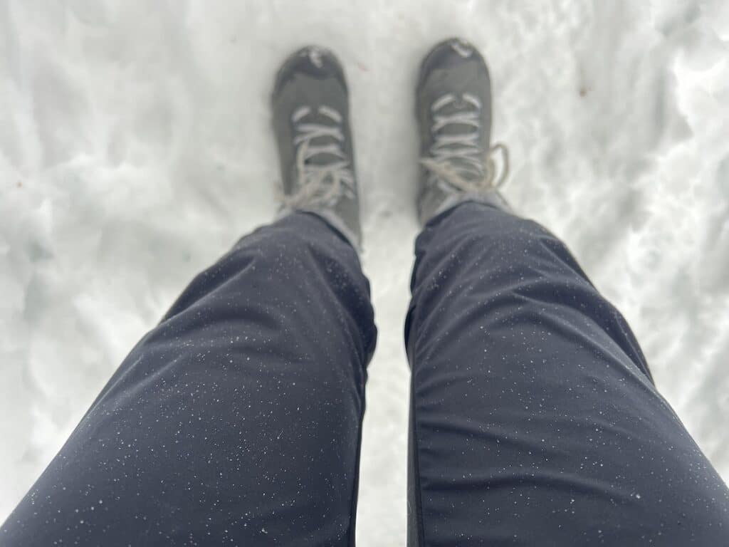 water droplets forming on craft advanced nordic training pants on a snowy winter hike