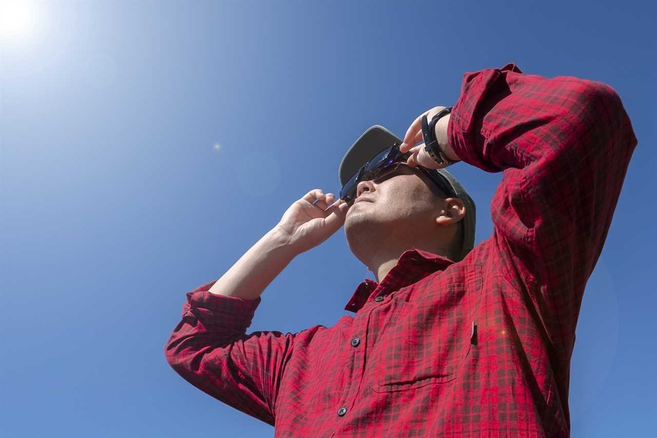 Man looking up at eclipse.