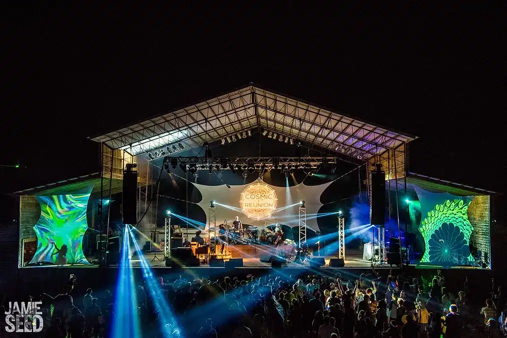 Stage with lasers shooting into audience.