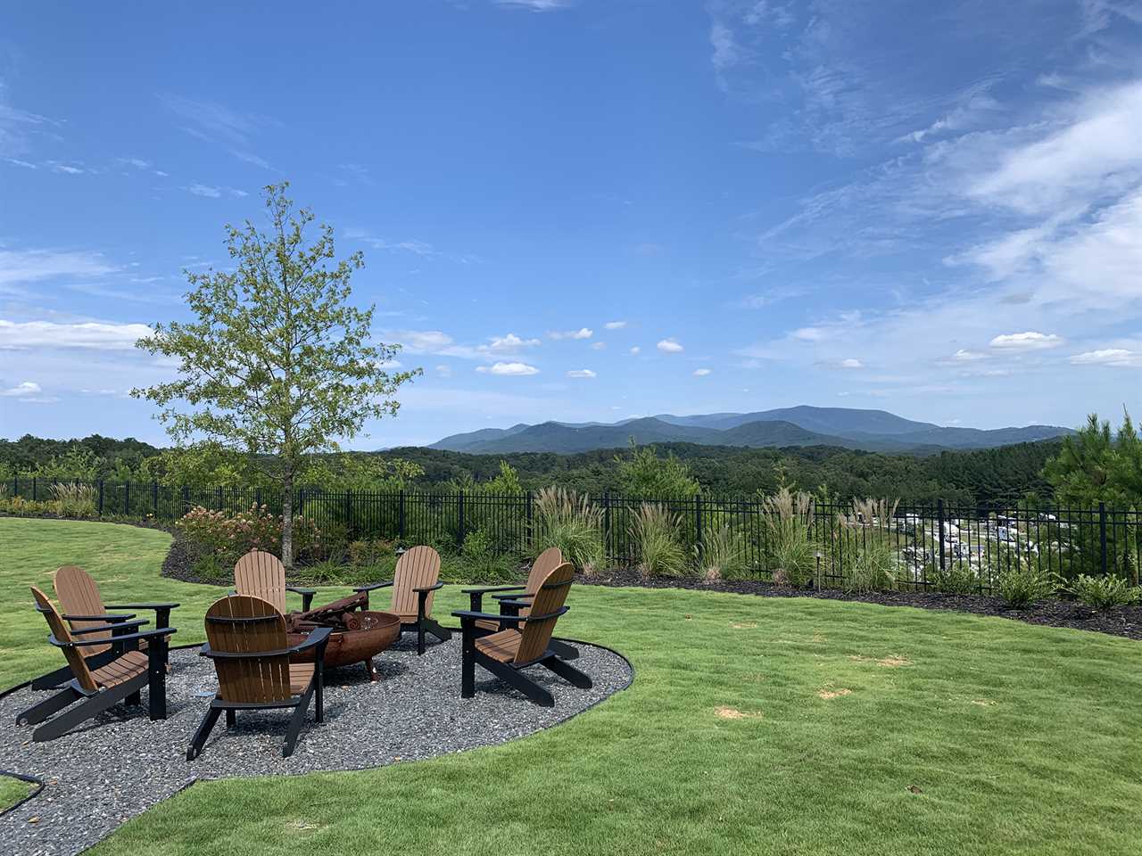 Taloma Adirondack chairs arrayed around a table with sweeping view in background.