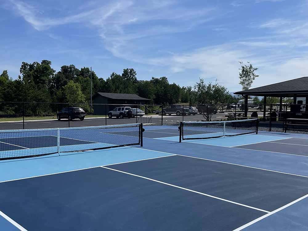 Picklball Blue pickleball courts in a resort setting