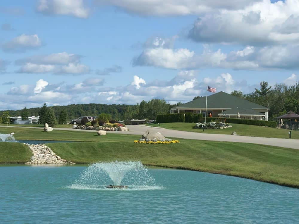 Clubhousein distance with pond in foreground.