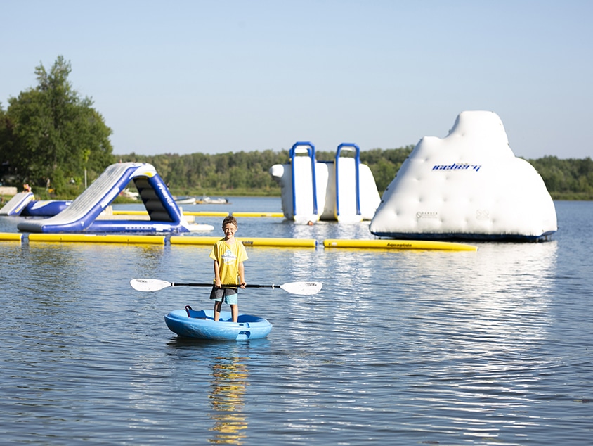 Kid on a standup paddleboard.