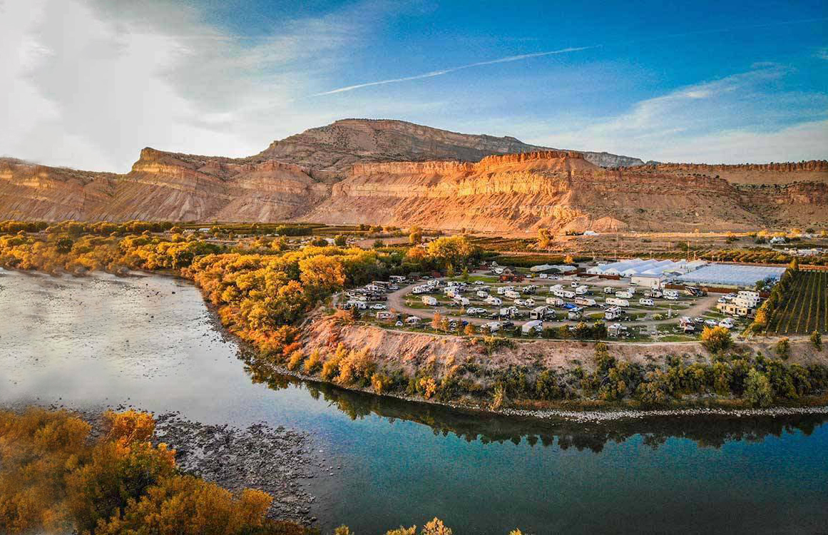 An RV park on the banks of a riverbend.