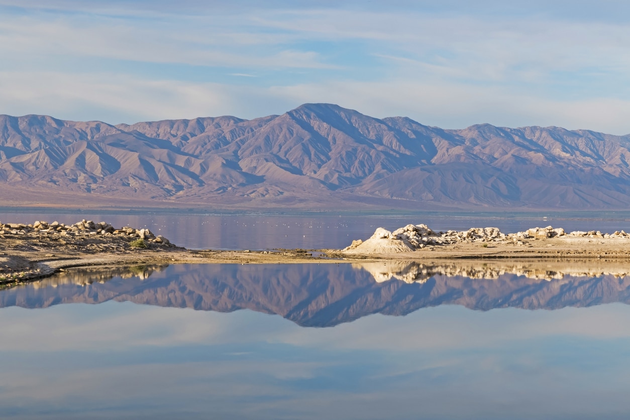 Mountains reflected on a serene lake surface.